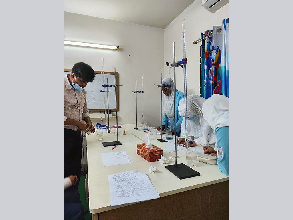 Students doing a titration experiment in science laboratory by the help of Lab Demonstrator